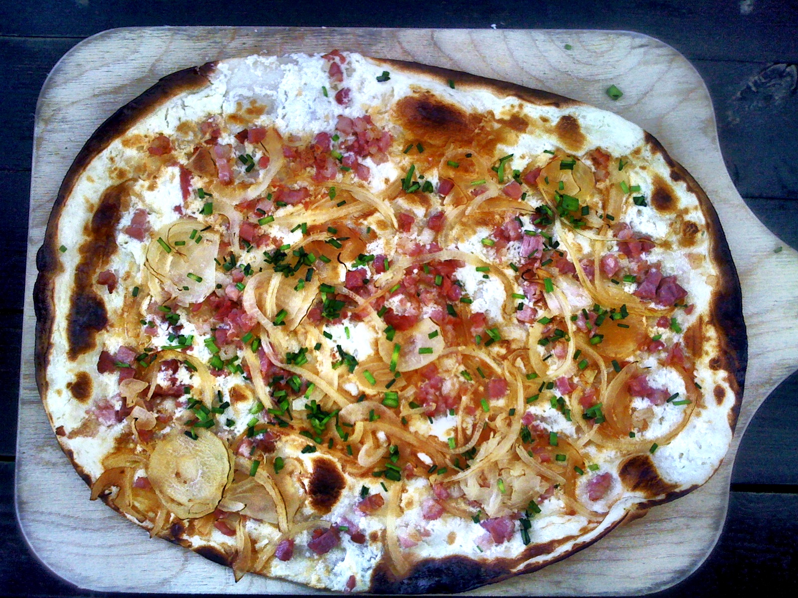 Una flammkuchen alsaziana sul tagliere.